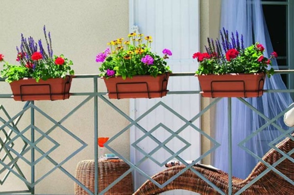 traditional approach flowerpots hung on the railing