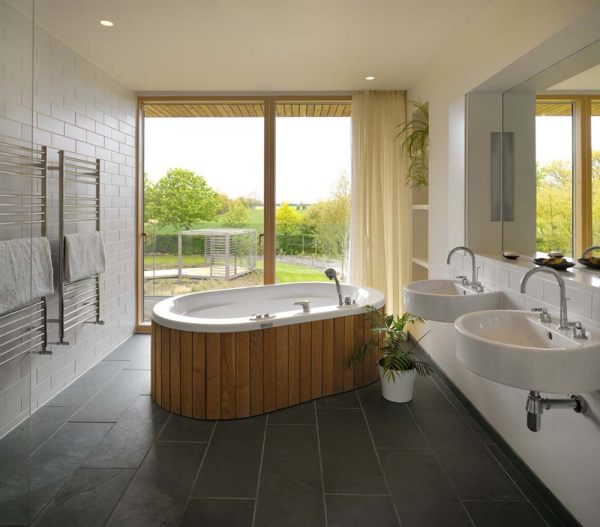 oval design bathtub covered with wooden slats