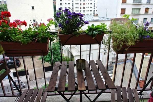 furnished balcony and planters on railing