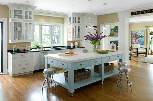 beautiful lighted kitchen with a mobile island with storage space