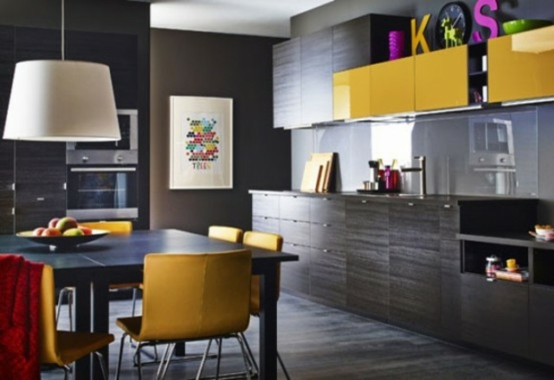 beautiful black kitchen accented by yellow furniture