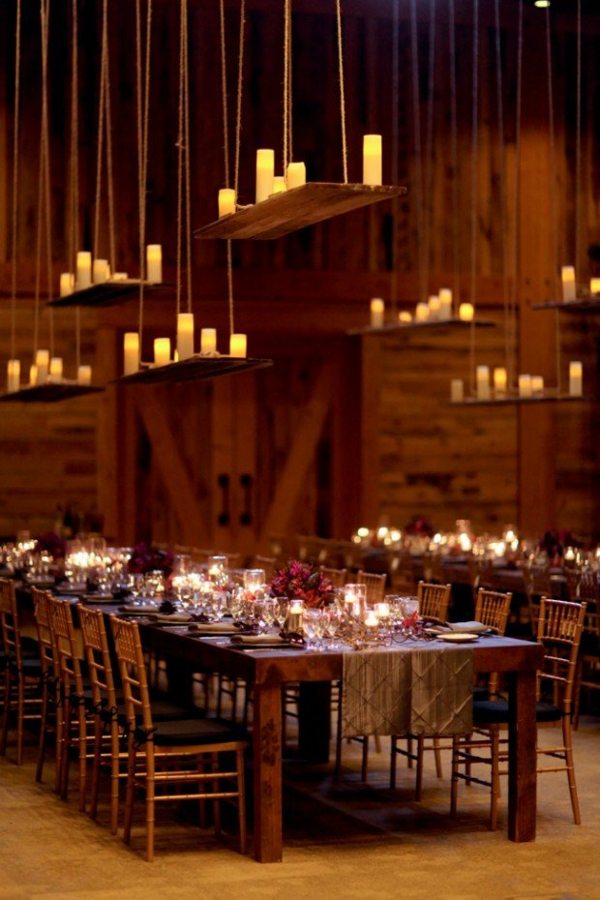 beautiful candles trays hanging from above dining tables