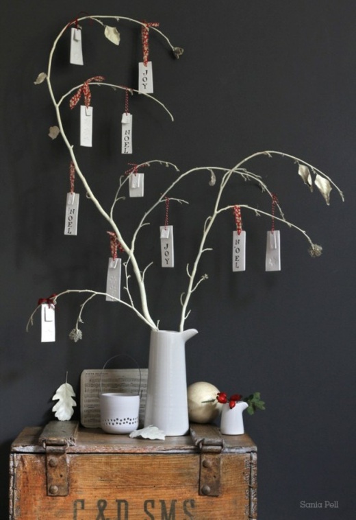 dead branches adorned with small sceneries in vase