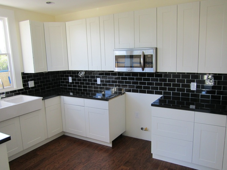 black metro tile backsplash white kitchen