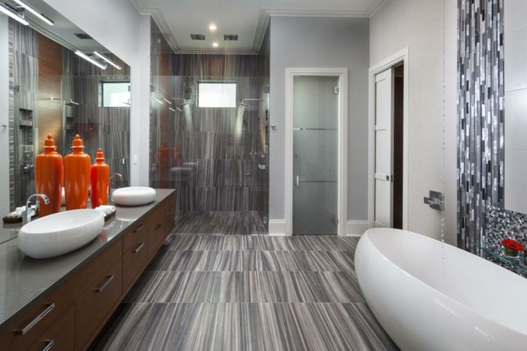 gray bathroom tile and wood rounded white bathtub