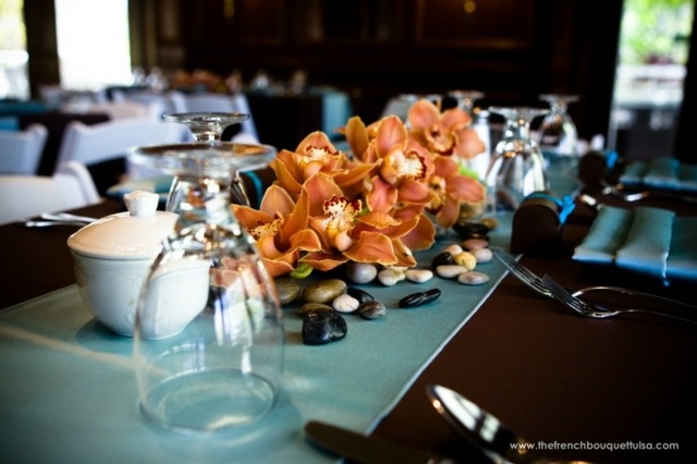 center table eats floral arrangement orchids oranges