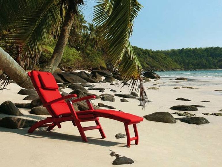 comfy reclining red lounge chair with armrests tectona original design at the beach relax