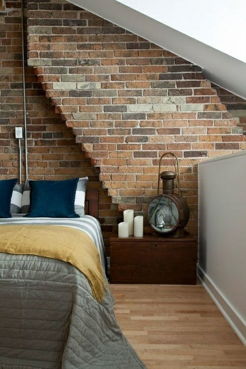 blue cushions view spacious bed wall bricks