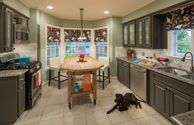 simple kitchen with island with wheels that also serves as a dining table