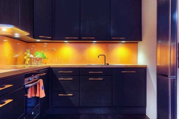 Sophisticated kitchen black cupboards yellow backsplash