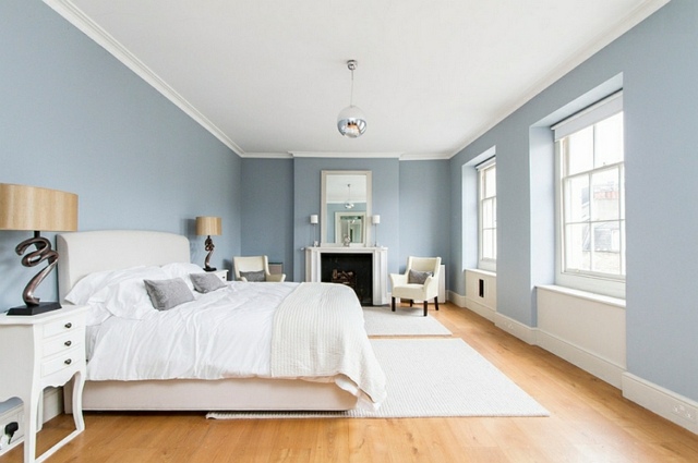 deci interior bedroom bed blue white fireplace