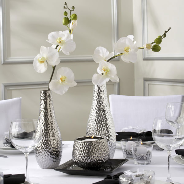 two orchids white vases silver dining table