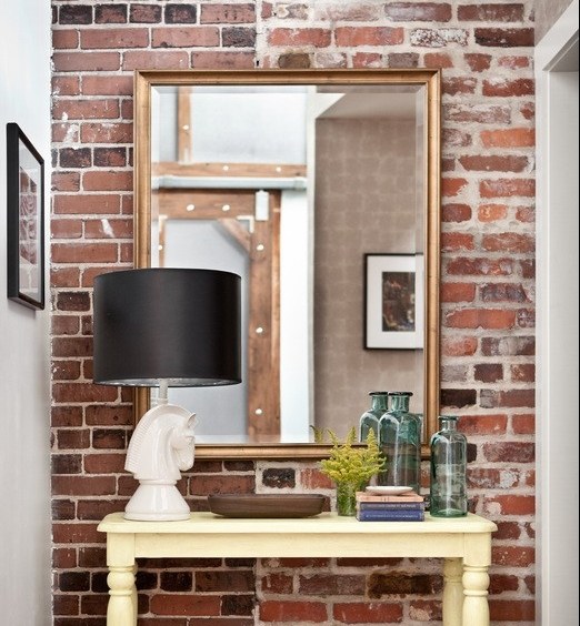 living room in red brick table mirror wall deco