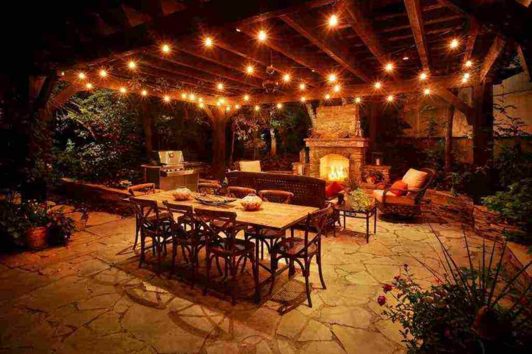 terrace lighting idea garland light garden furniture armchair dining table chair wood design stone