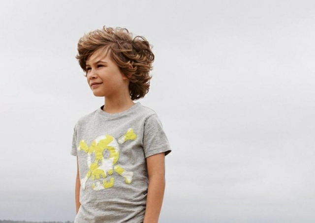 boy with curly hair wind beach modern california haircut boy