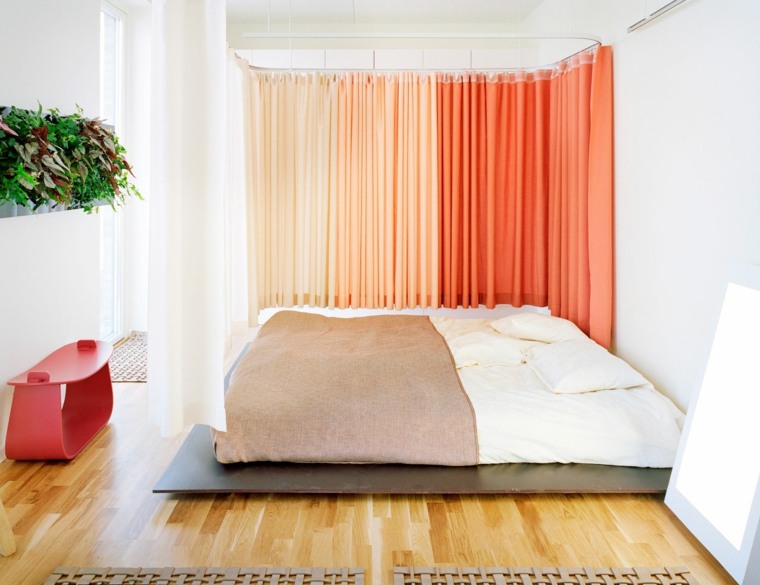 bed on floor gay room bright orange shades