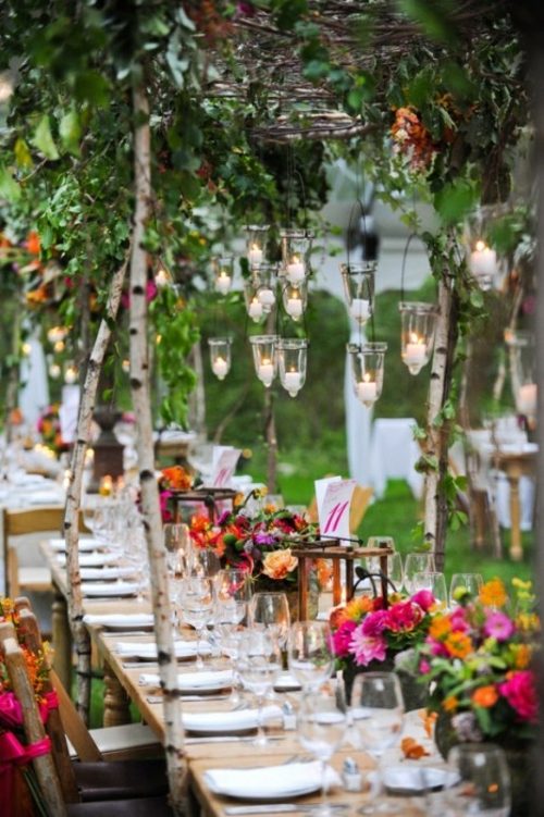 outdoor wedding lanterns and flowers in abundance