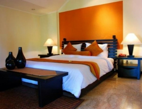 orange wall big wooden bed