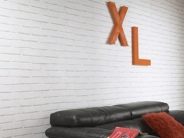 white imitation white brick wallpaper black leather sofa