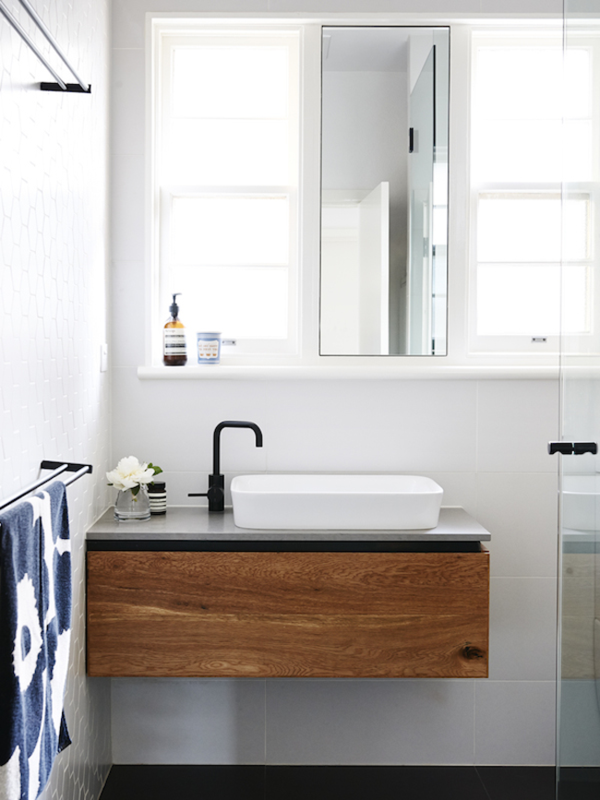 Small vanity in dark wood contrast white wall