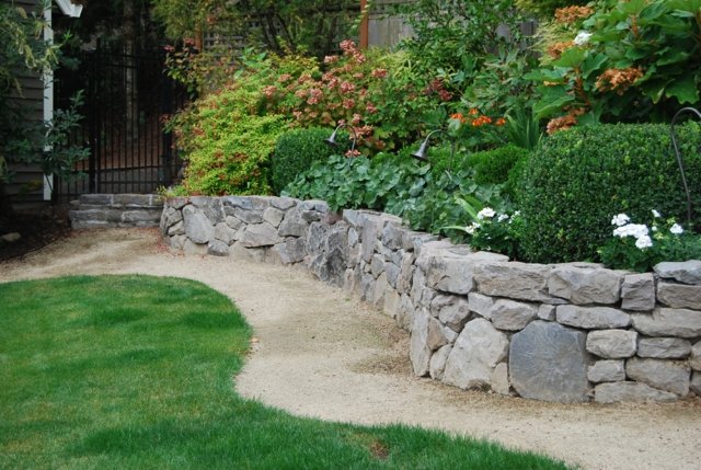 small stone wall beautiful garden