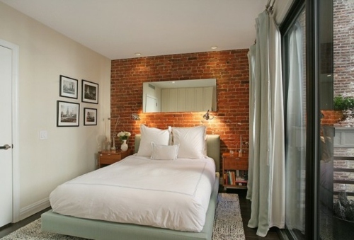 small room comfortable bed wall bricks