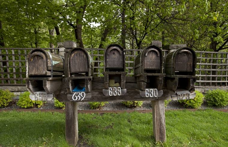 several rustic wood mailboxes