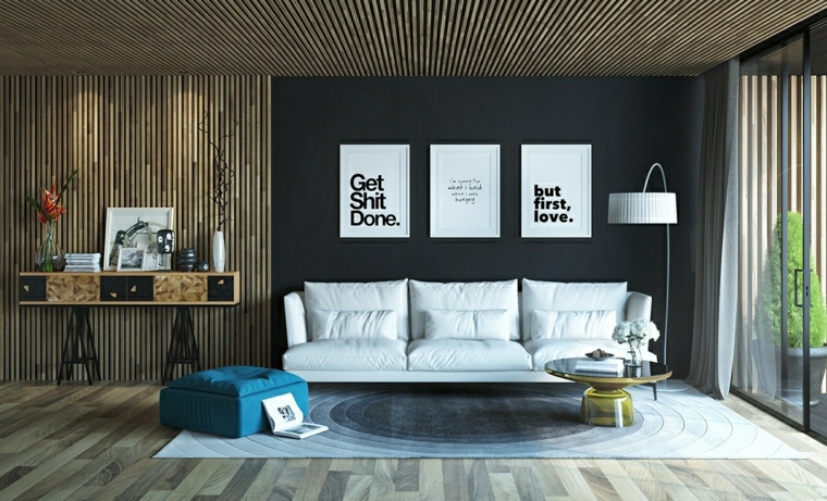 wall decoration living room design frames composition sofa white cushions wall wood flooring gray blue pouf