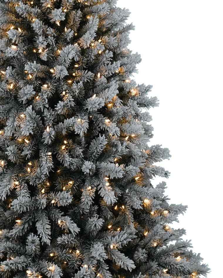 artificial fir snow effect delicately decorated small lights