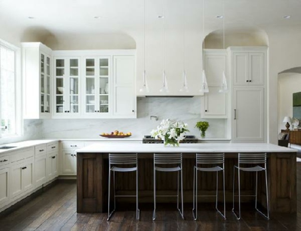 superb white kitchen with an island covered with wood