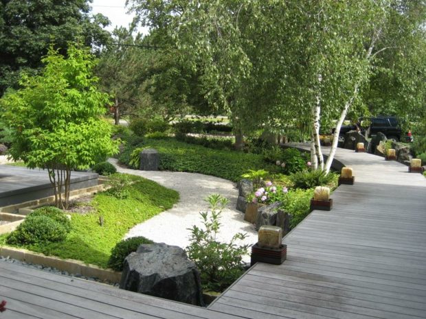 beautiful Zen garden with wooden promenade bridge