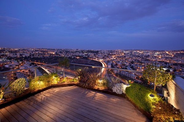 beautiful wooden terrace dotted with solar lights