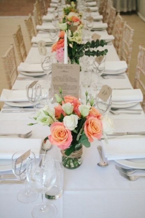 Wedding table punctuated with pink vases