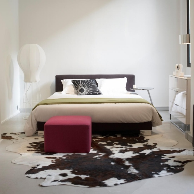 carpet-skin-cow-brown-white-bed-bed-stool-bordeaux-lamp-white