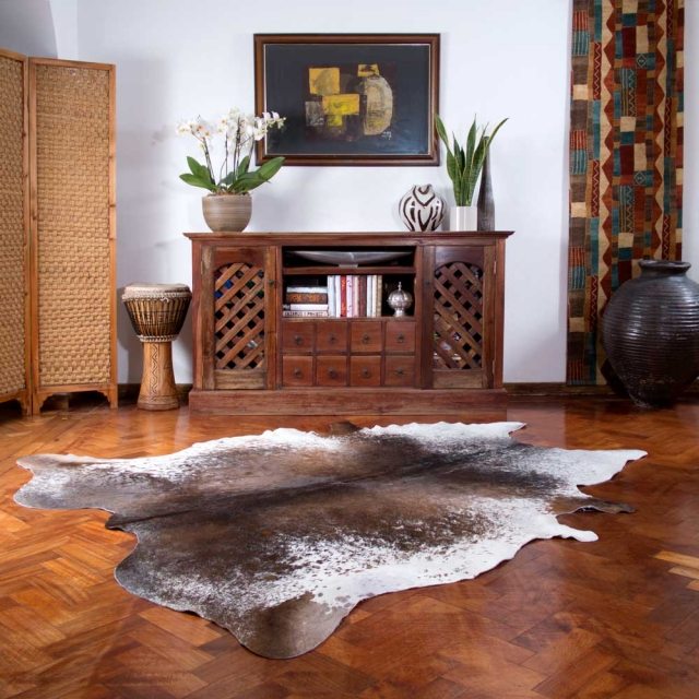 carpet-skin-cow-brown-white-dresser-wood-orchids-white rug cowhide