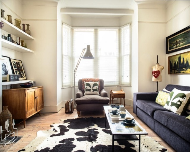 carpet-skin-cow-black-white-sofa-black-armchair-cushions-decorative-living room carpet cowhide