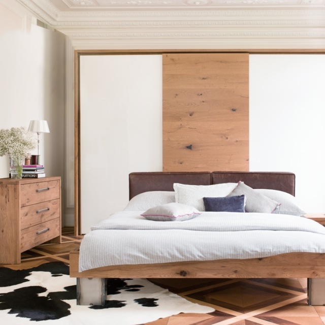 carpet-hide-cow-black-white-bedroom-bed-bed-dresser-wood rug cowhide