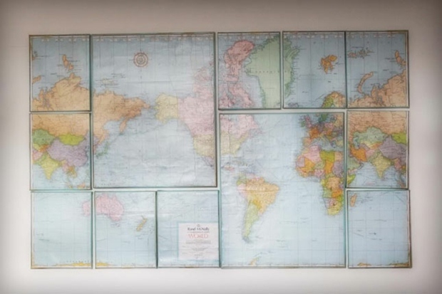 a puzzle of canvases adorned with world maps