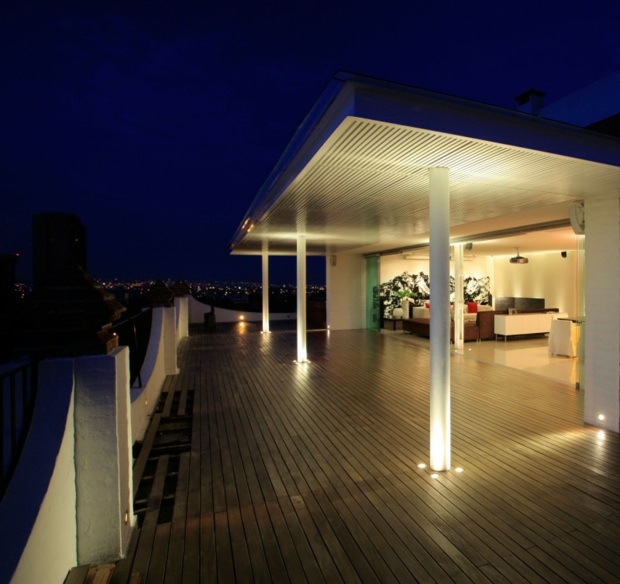 large terrace with columns lit by spotlights